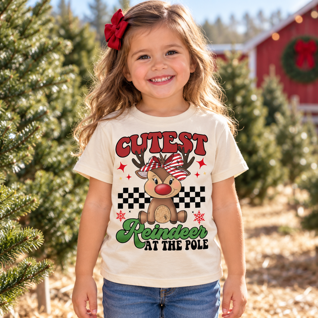 Girl wearing Cutest Reindeer at the Pole natural Christmas tee