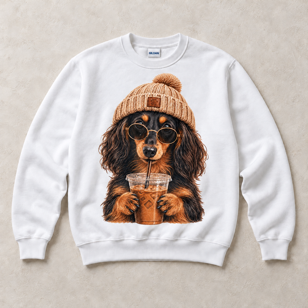 White Gildan crewneck sweatshirt with Long Haired Dachshund Iced Coffee graphic, front flat lay