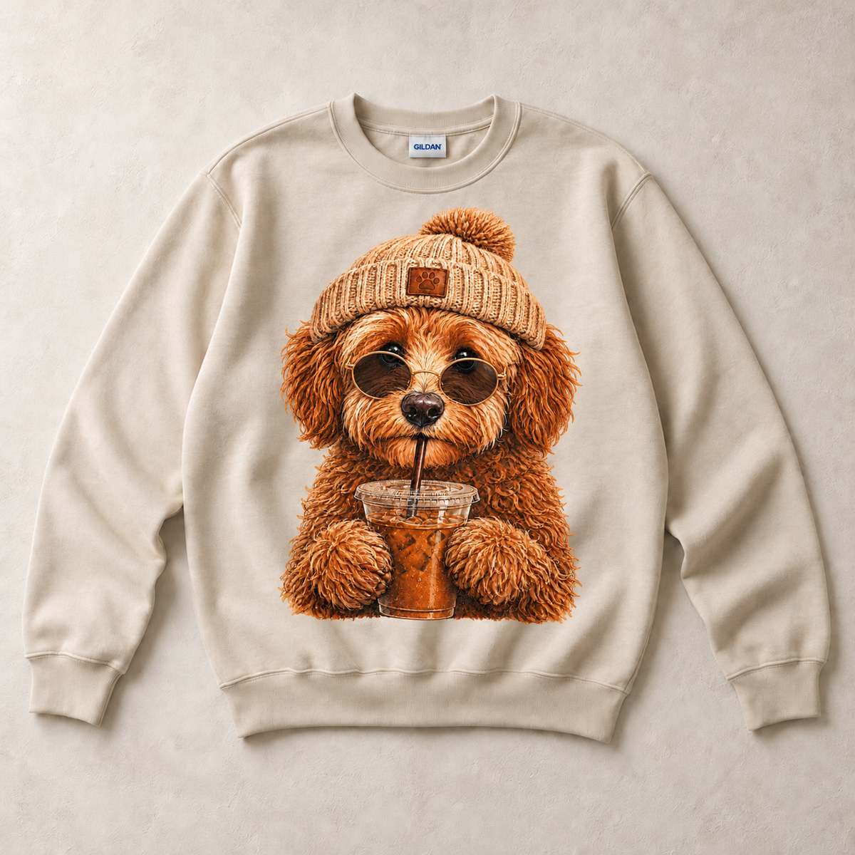 Sand Gildan crewneck sweatshirt with Doodle Iced Coffee graphic, front flat lay