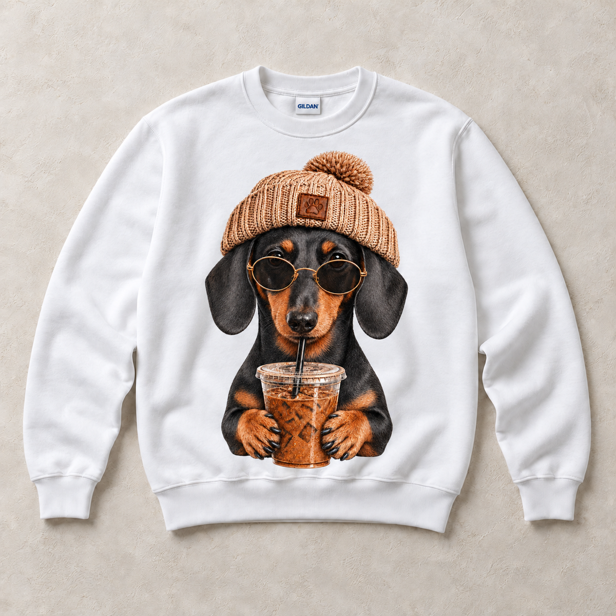 White Gildan crewneck sweatshirt with Dachshund Iced Coffee graphic, front flat lay