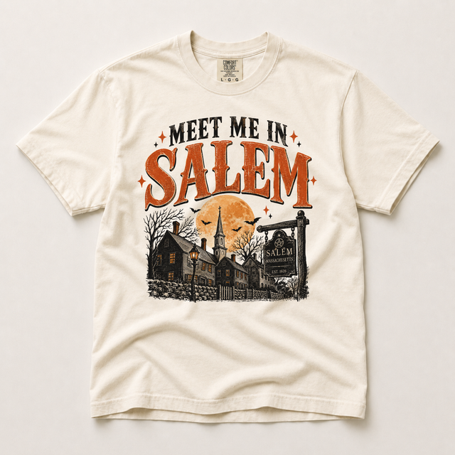 Ivory Comfort Colors Meet Me in Salem Halloween shirt with distressed orange lettering, a full moon, bats and vintage Salem buildings
