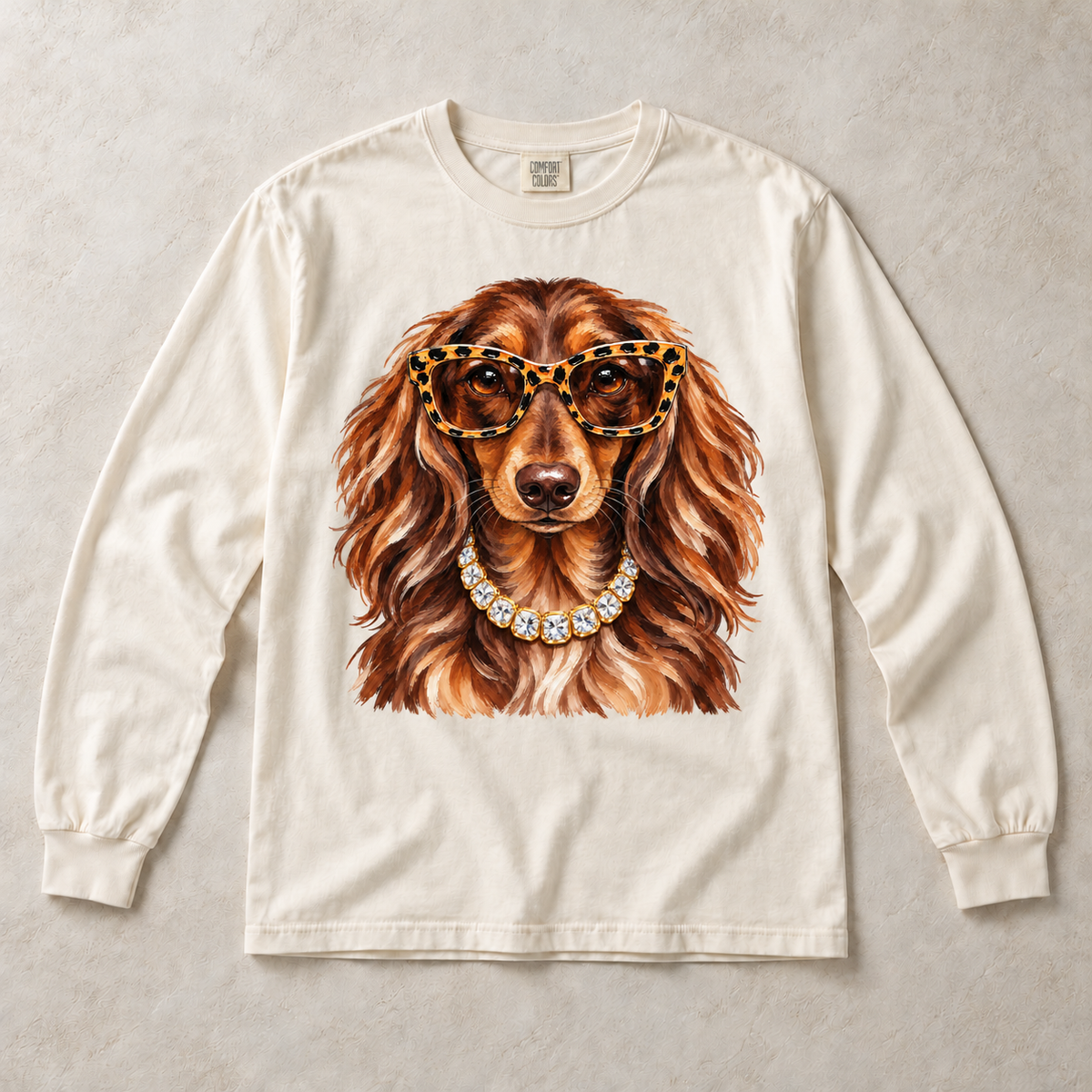 Ivory Comfort Colors long-sleeve T-shirt with Dachshund Leopard Glasses graphic, front flat lay