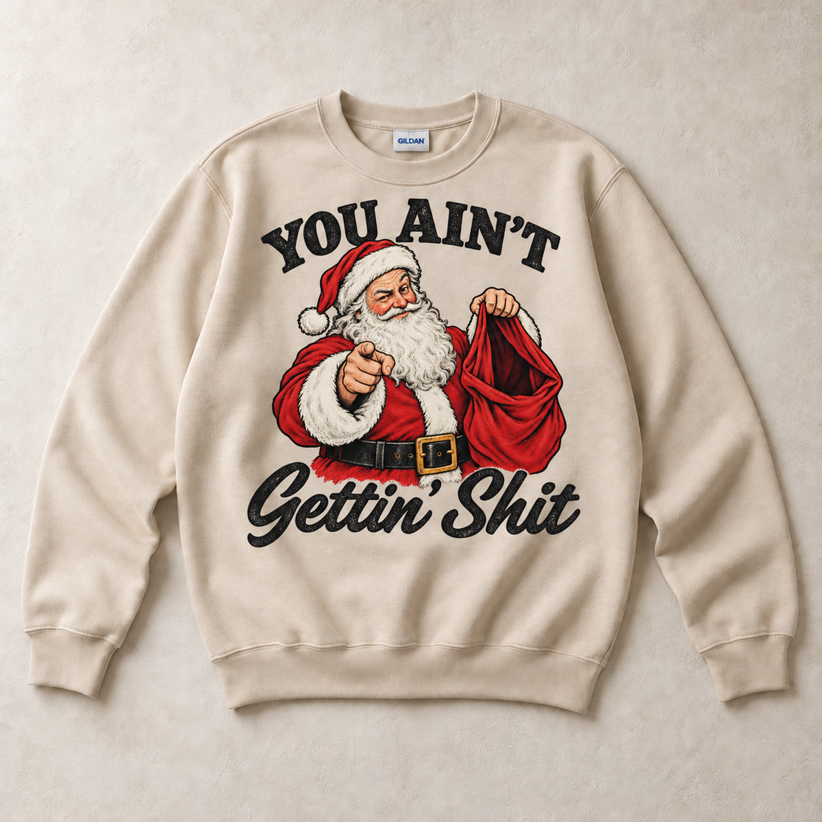 Sand Gildan crewneck sweatshirt with You Ain't Gettin' Shit Funny Santa Christmas graphic, front flat lay