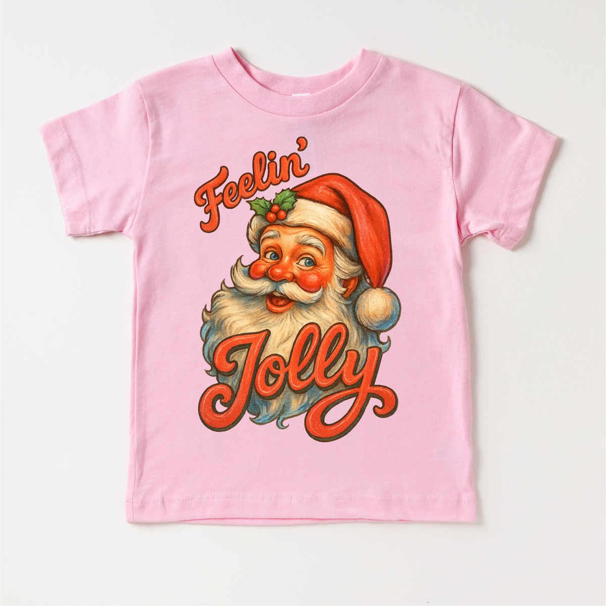 Feelin' Jolly Santa Christmas design on a pink garment.