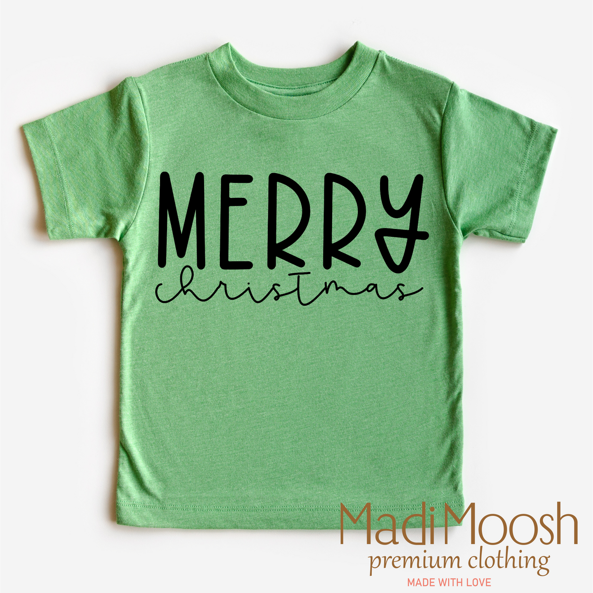 Classic Merry Christmas design on a green garment.
