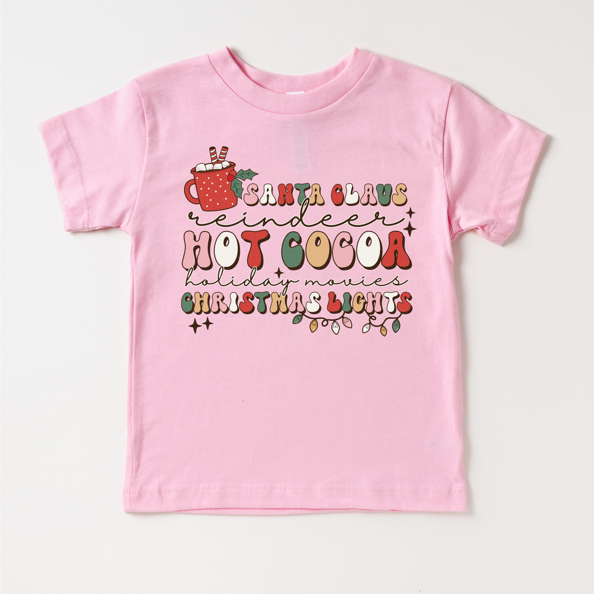 Hot Cocoa Reindeer Christmas design on a pink garment.