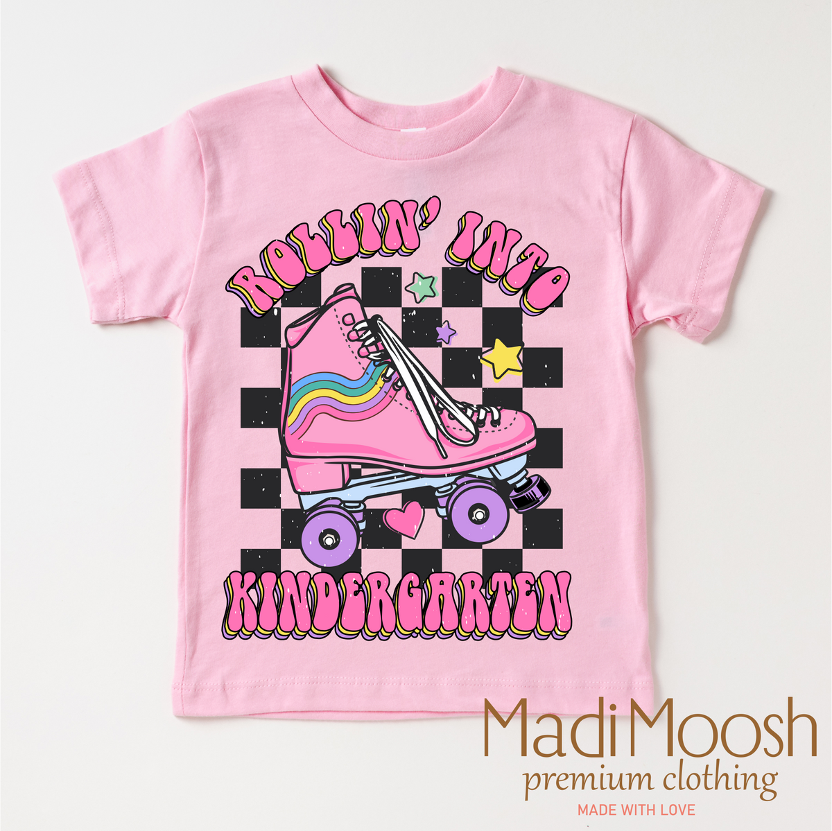 Rollin Into Kindergarten Back To School design on a pink garment.