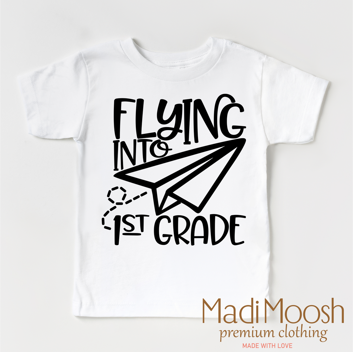 Flying Into First Grade Back To School design on a white garment.