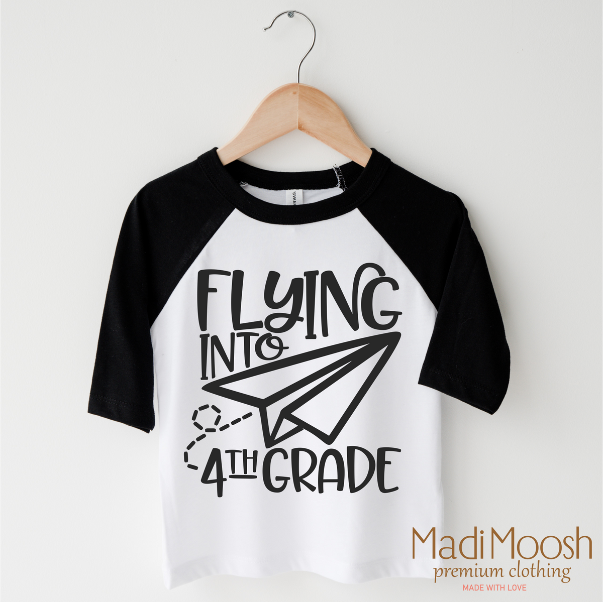 Flying Into 4th Grade Back To School design on a black-accented shirt.