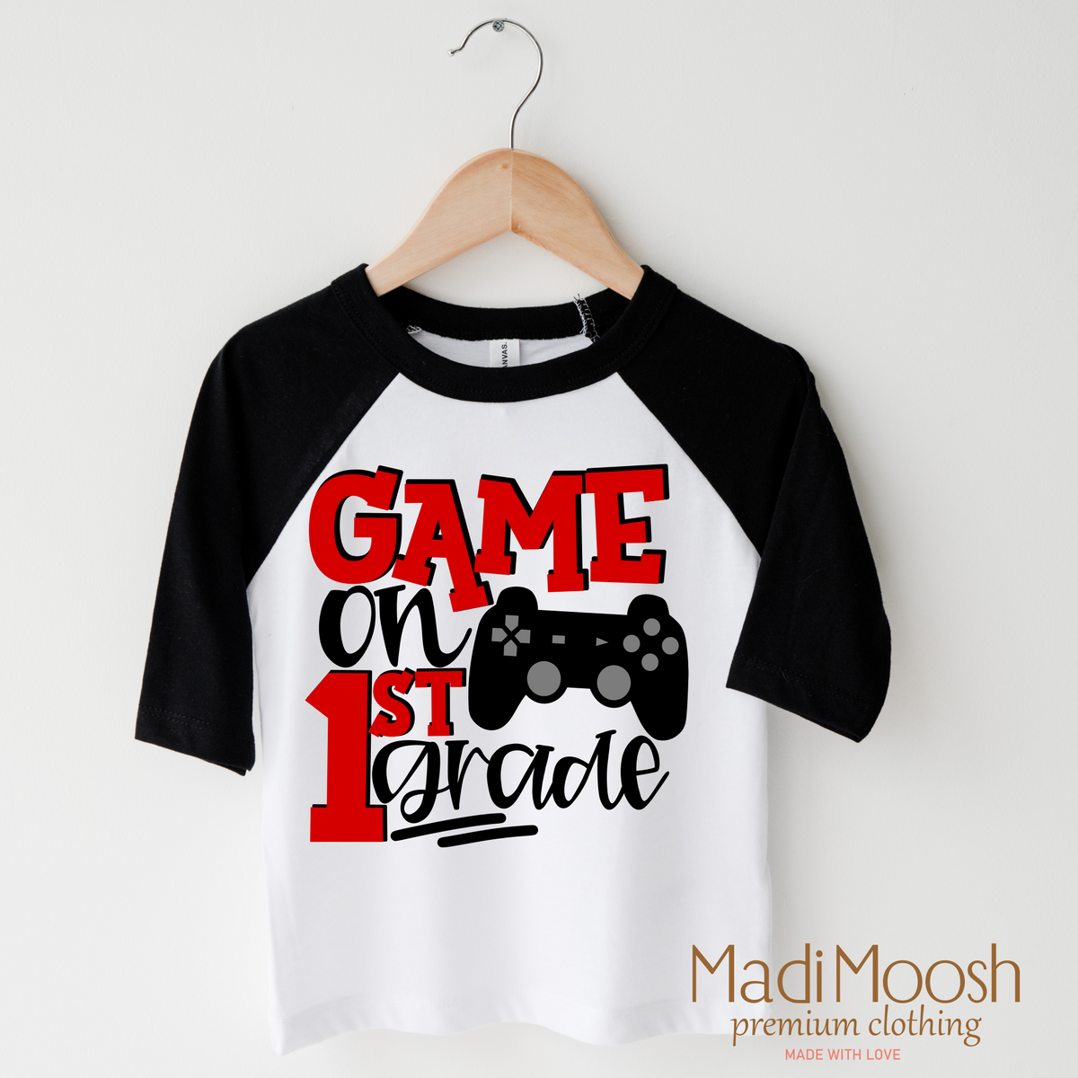 Game On First Grade Back To School design on a raglan shirt with black sleeves.