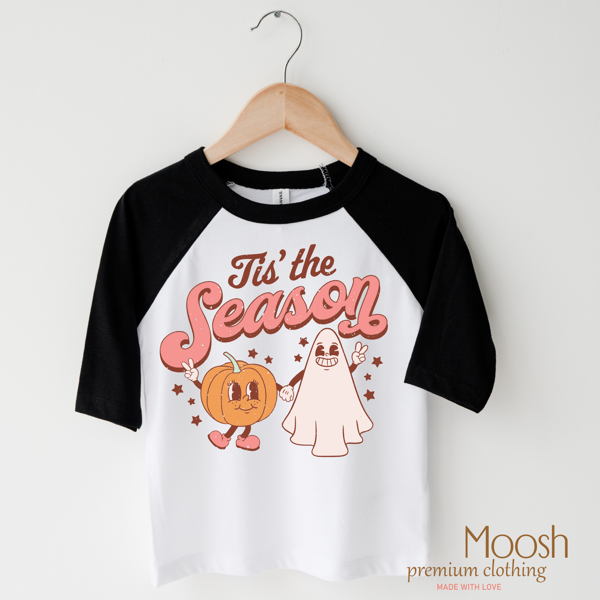Tis The Season design on a raglan shirt with black sleeves.