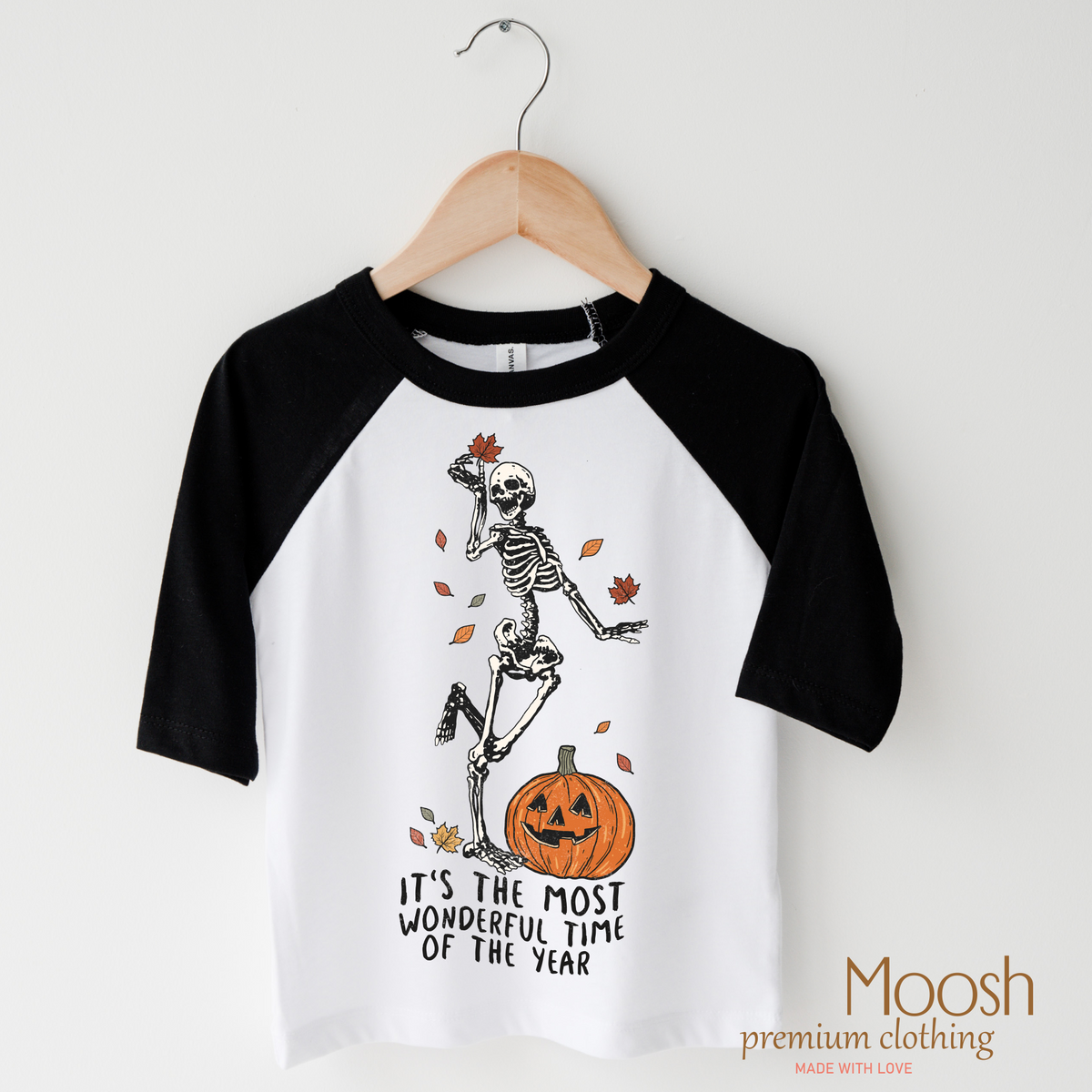 It's The Most Wonderful Time Of The Year design on a raglan shirt with black sleeves.