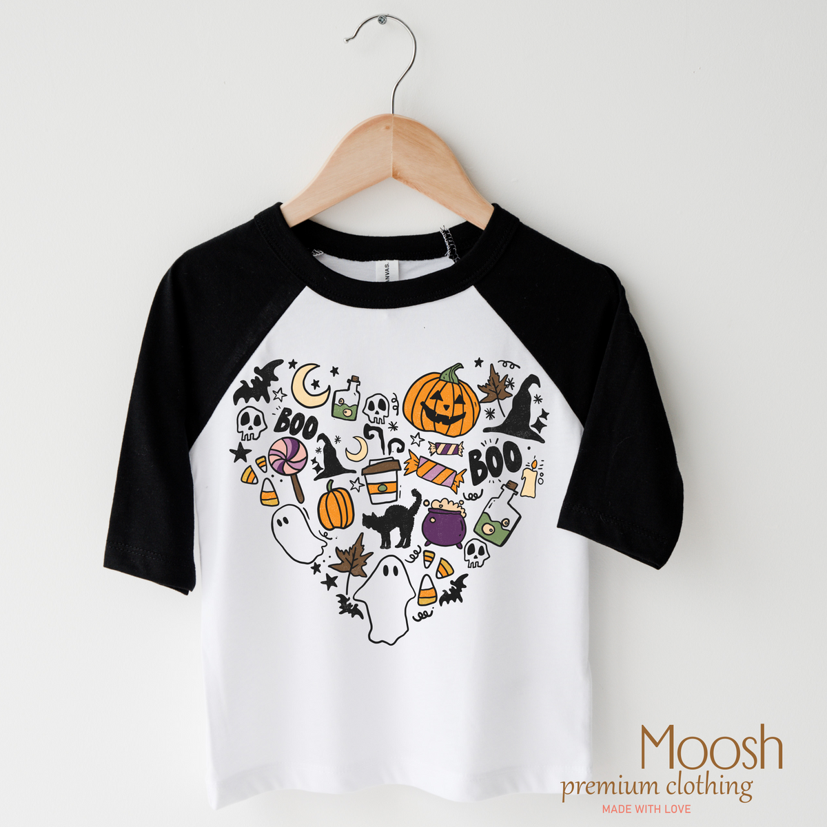I Love Halloween Heart design on a raglan shirt with black sleeves.