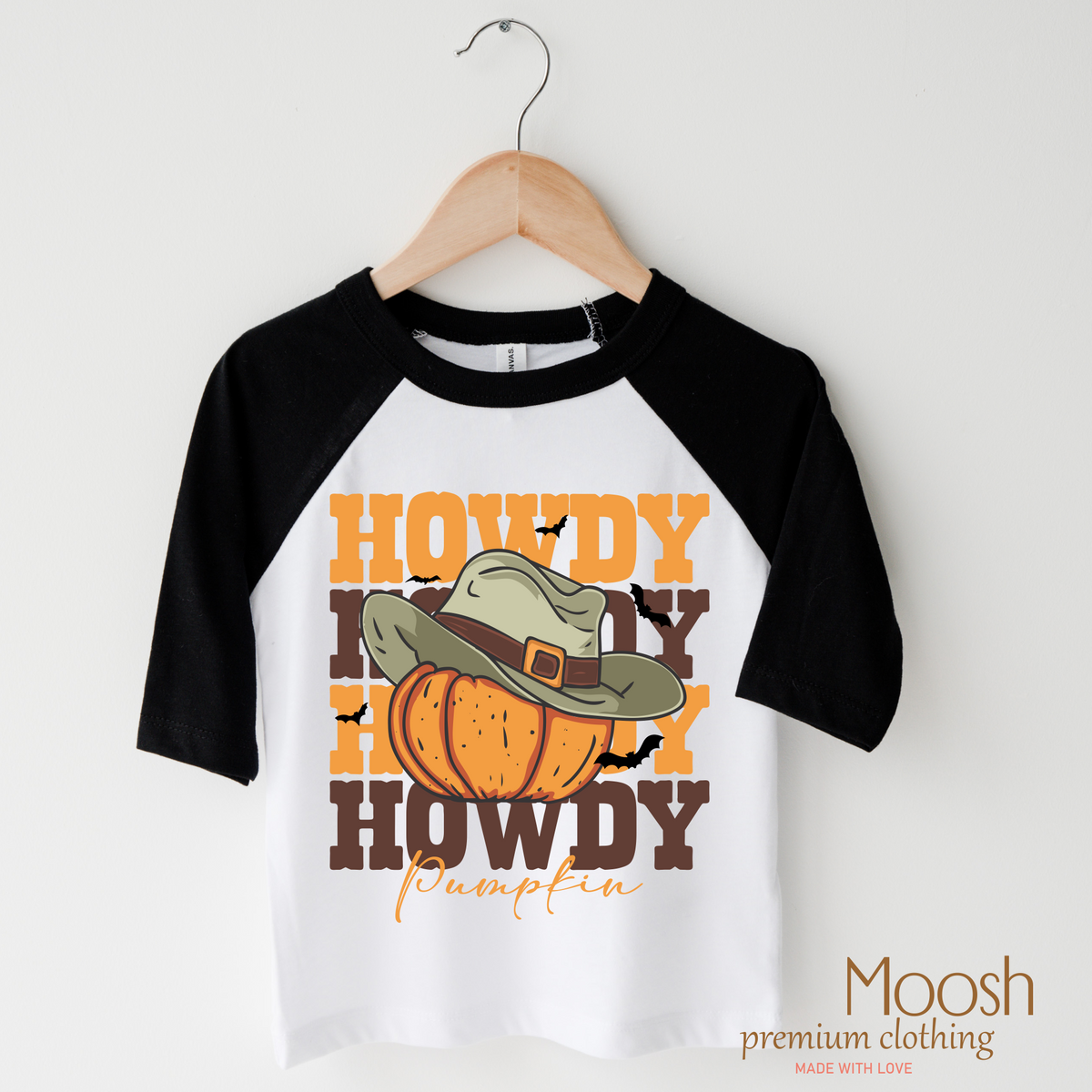 Howdy Pumpkin design on a raglan shirt with black sleeves.