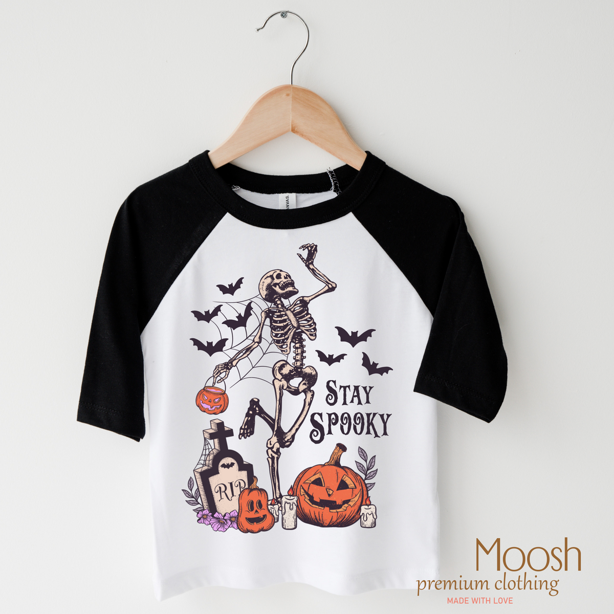 Stay Spooky design on a raglan shirt with black sleeves.
