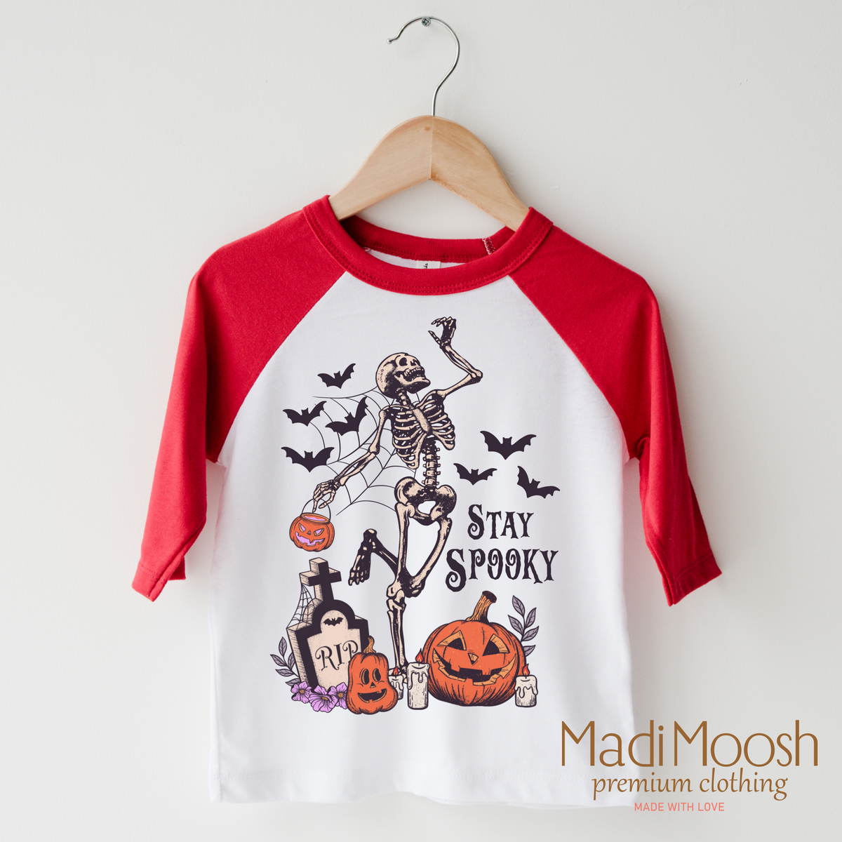 Stay Spooky design on a raglan shirt with red sleeves.