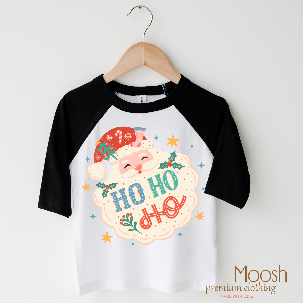 Ho Ho Ho Santa design on a raglan shirt with black sleeves.