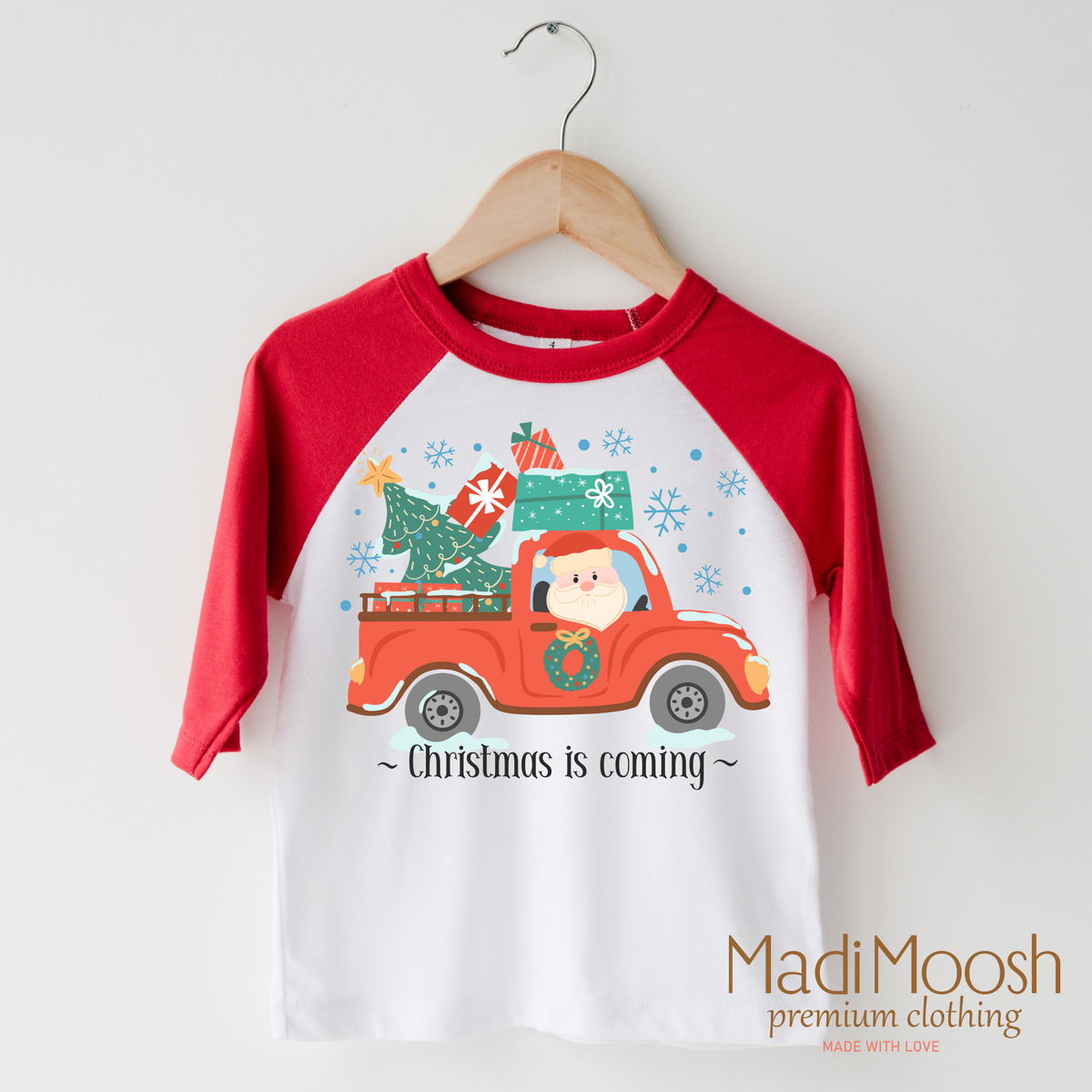 Christmas Is Coming design on a raglan shirt with red sleeves.