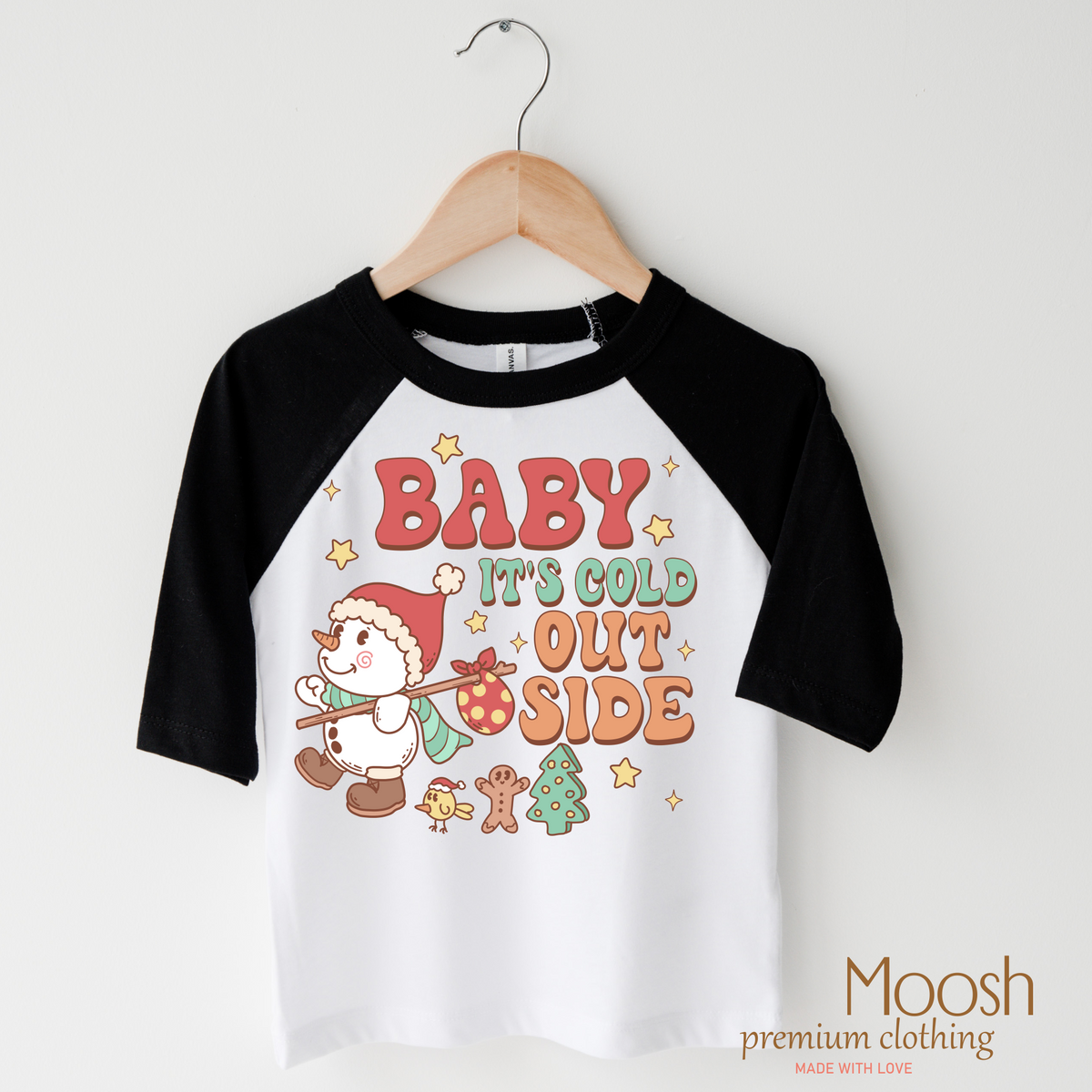 Baby It's Cold Outside Christmas design on a black-accented shirt.