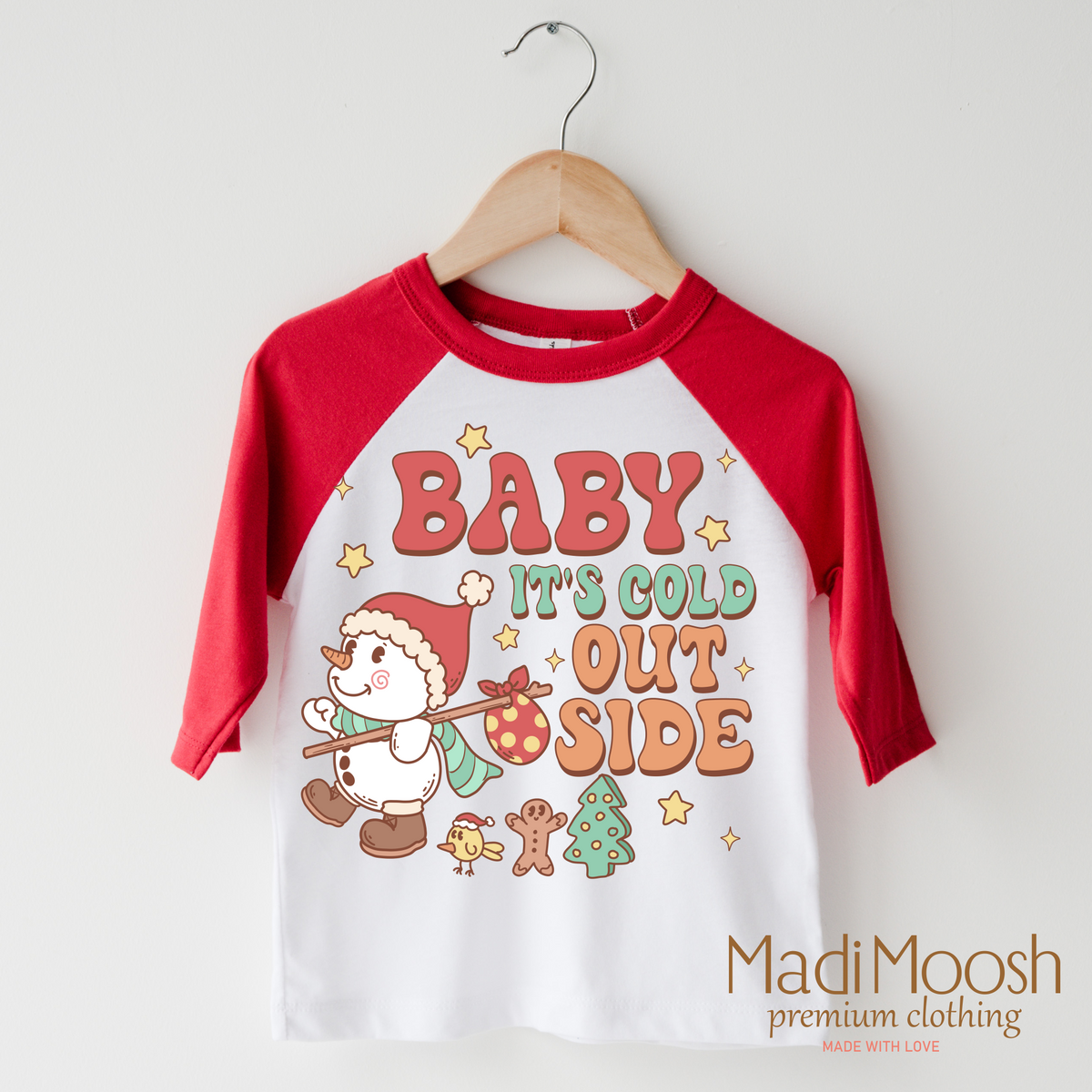 Baby It's Cold Outside Christmas design on a red-accented shirt.