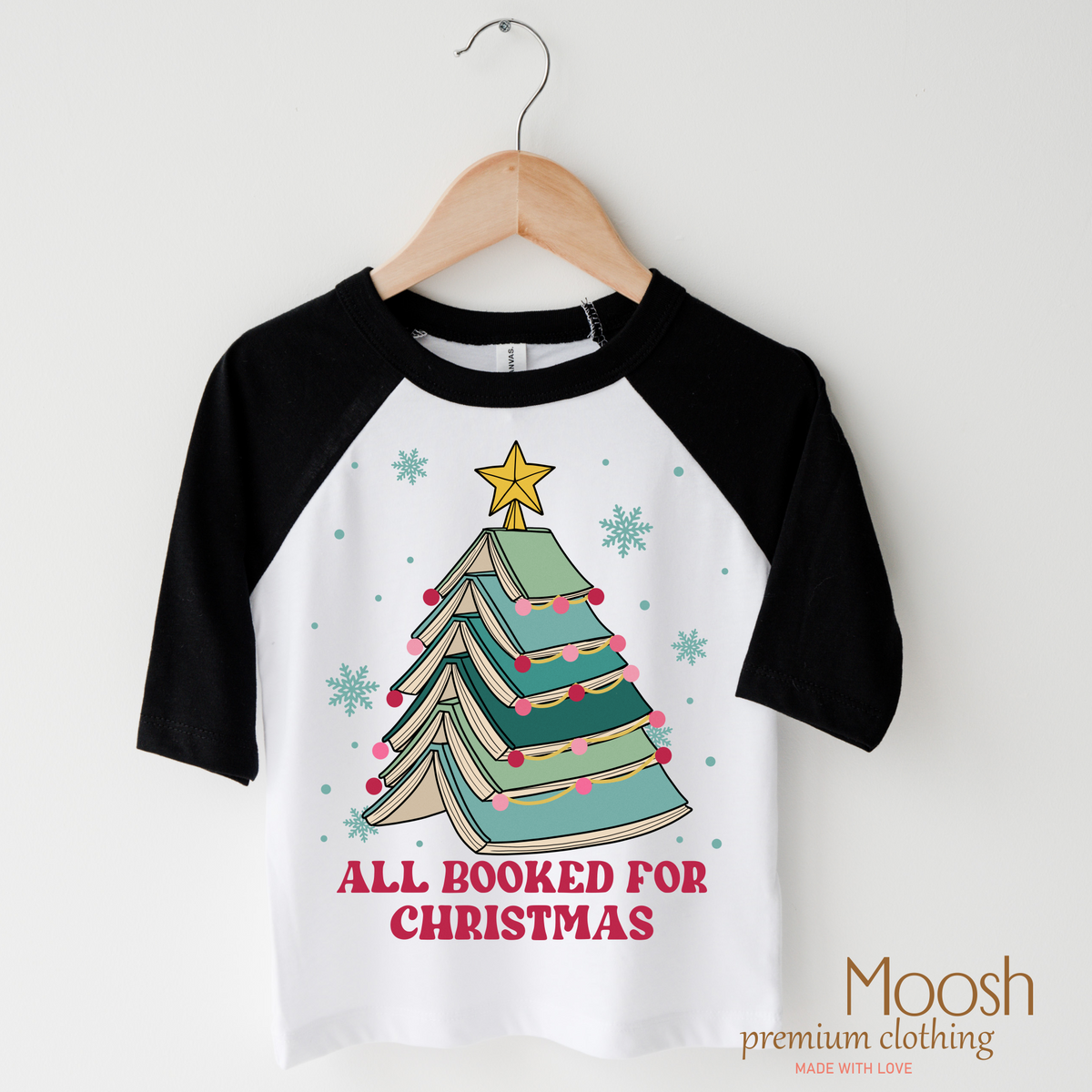 All Booked for Christmas design on a black-accented shirt.