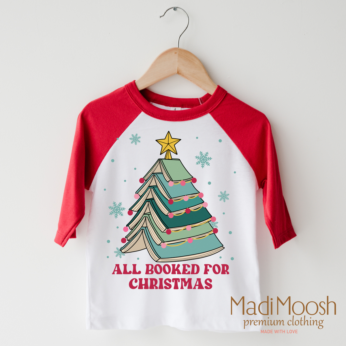 All Booked for Christmas design on a red-accented shirt.