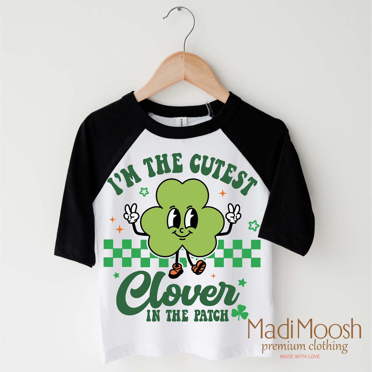 I'm The Cutest Clover In The Patch St. Patrick's Day design on a black-accented shirt.