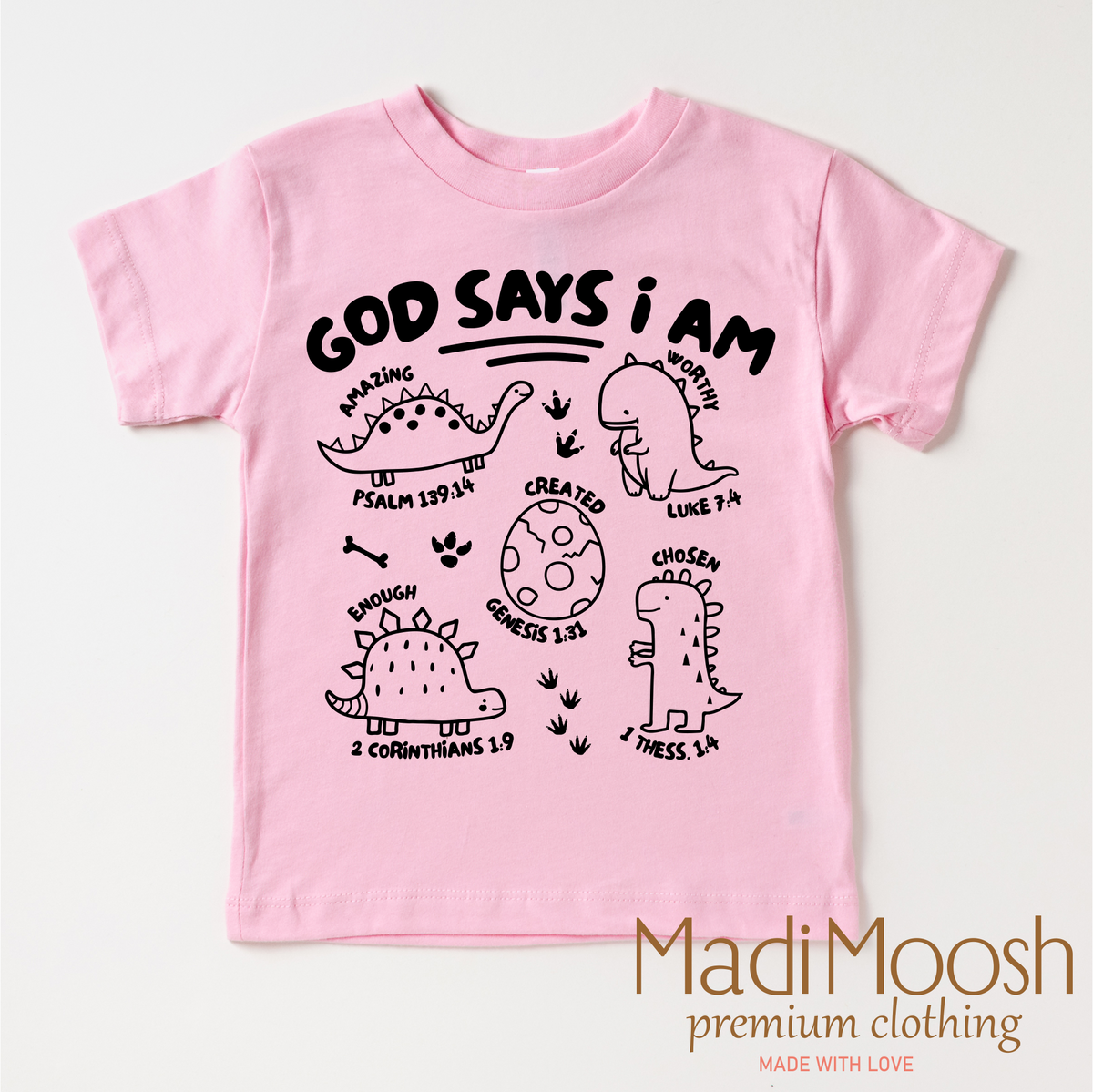 God Says I Am Dinosaur design on a pink garment.
