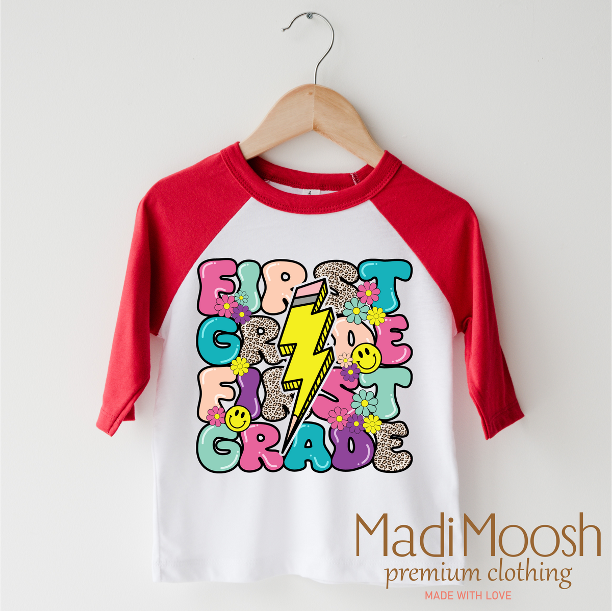 First Grade Lightning Bolt Back To School design on a red-accented shirt.