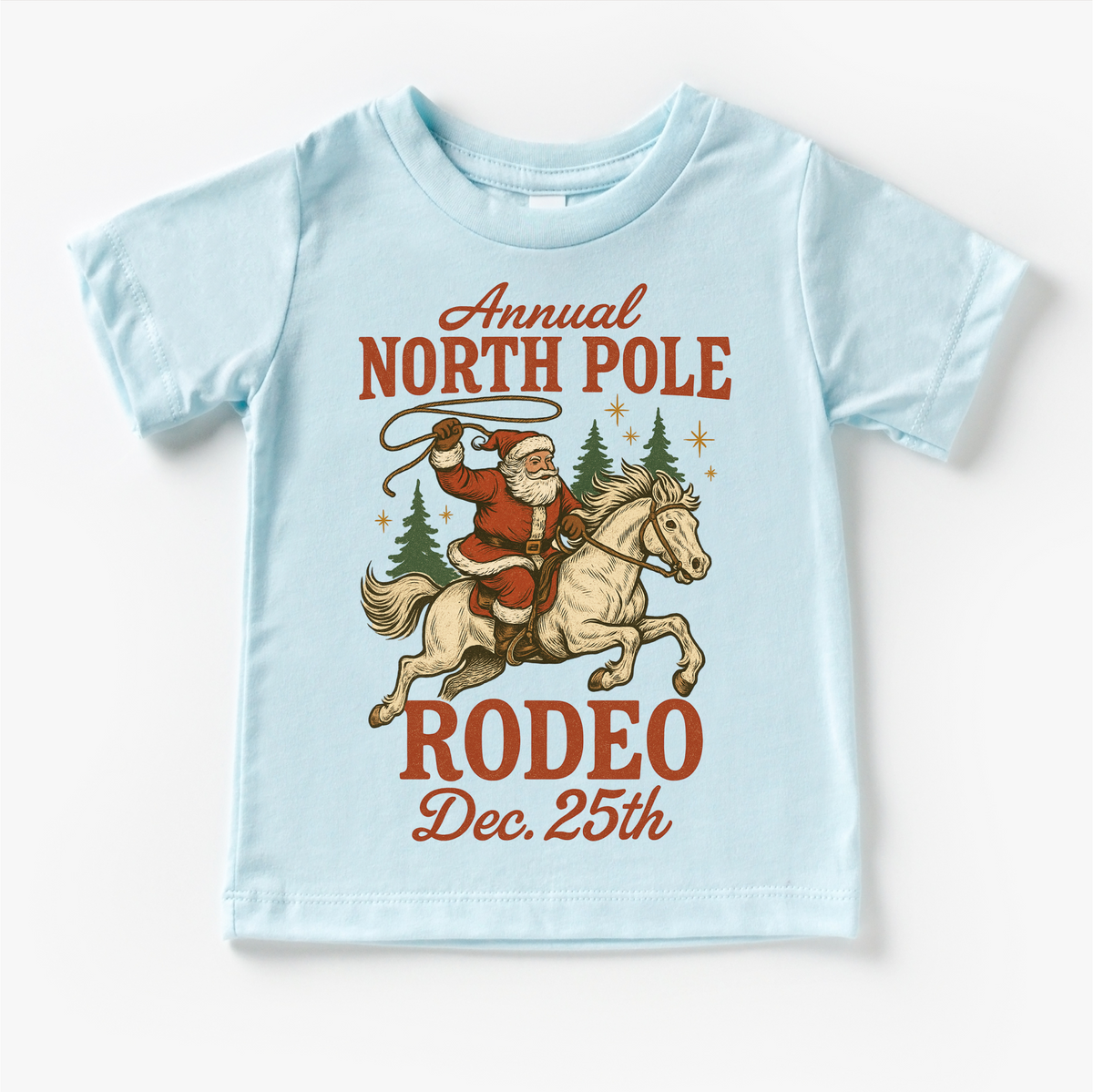 North Pole Rodeo Cowboy Christmas design on a blue garment.
