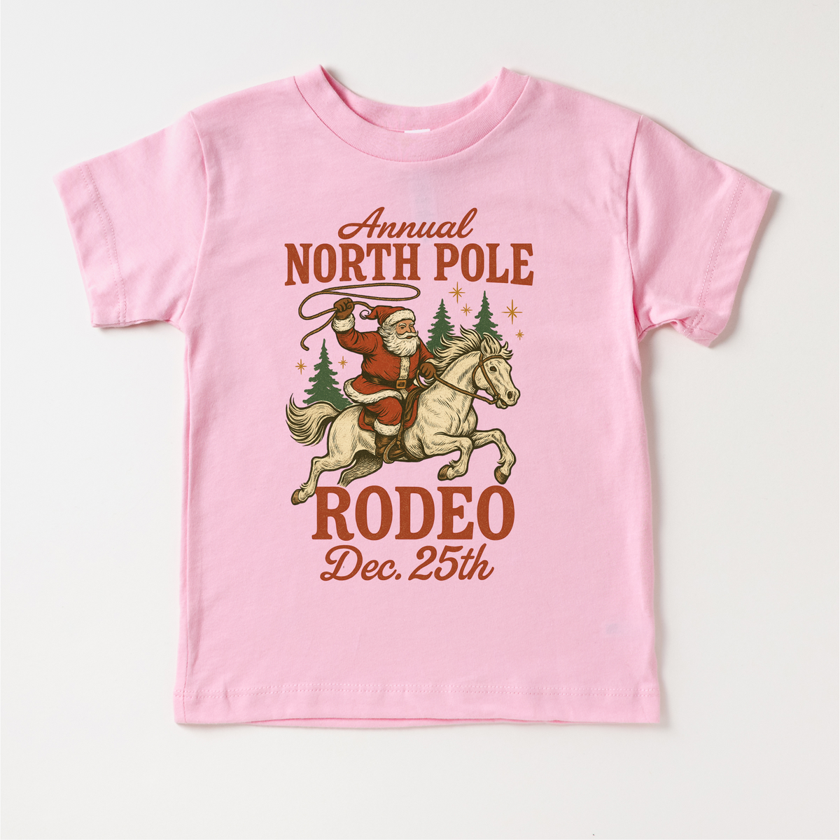 North Pole Rodeo Cowboy Christmas design on a pink garment.