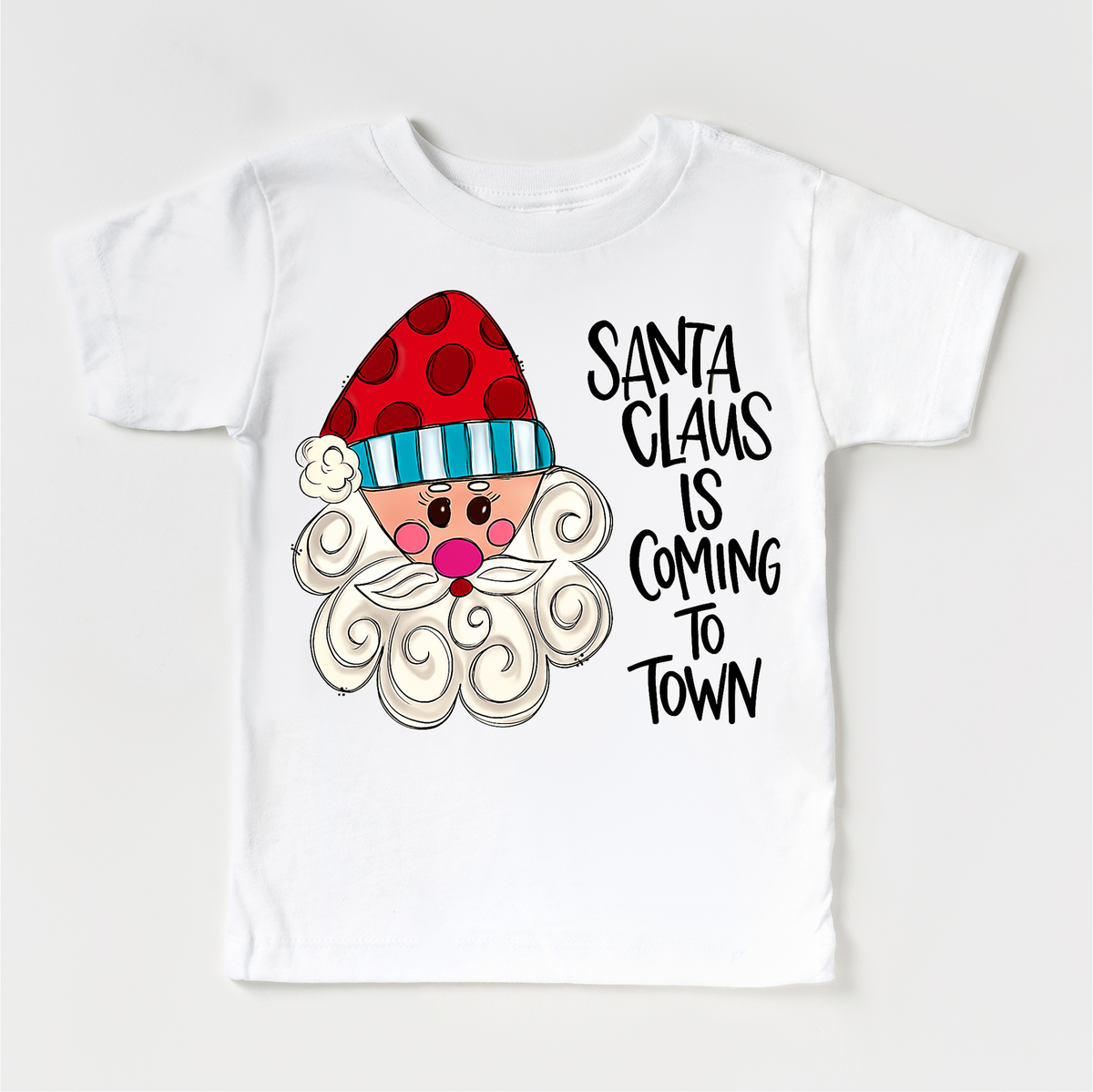 Santa Claus Is Coming To Town Christmas design on a white garment.