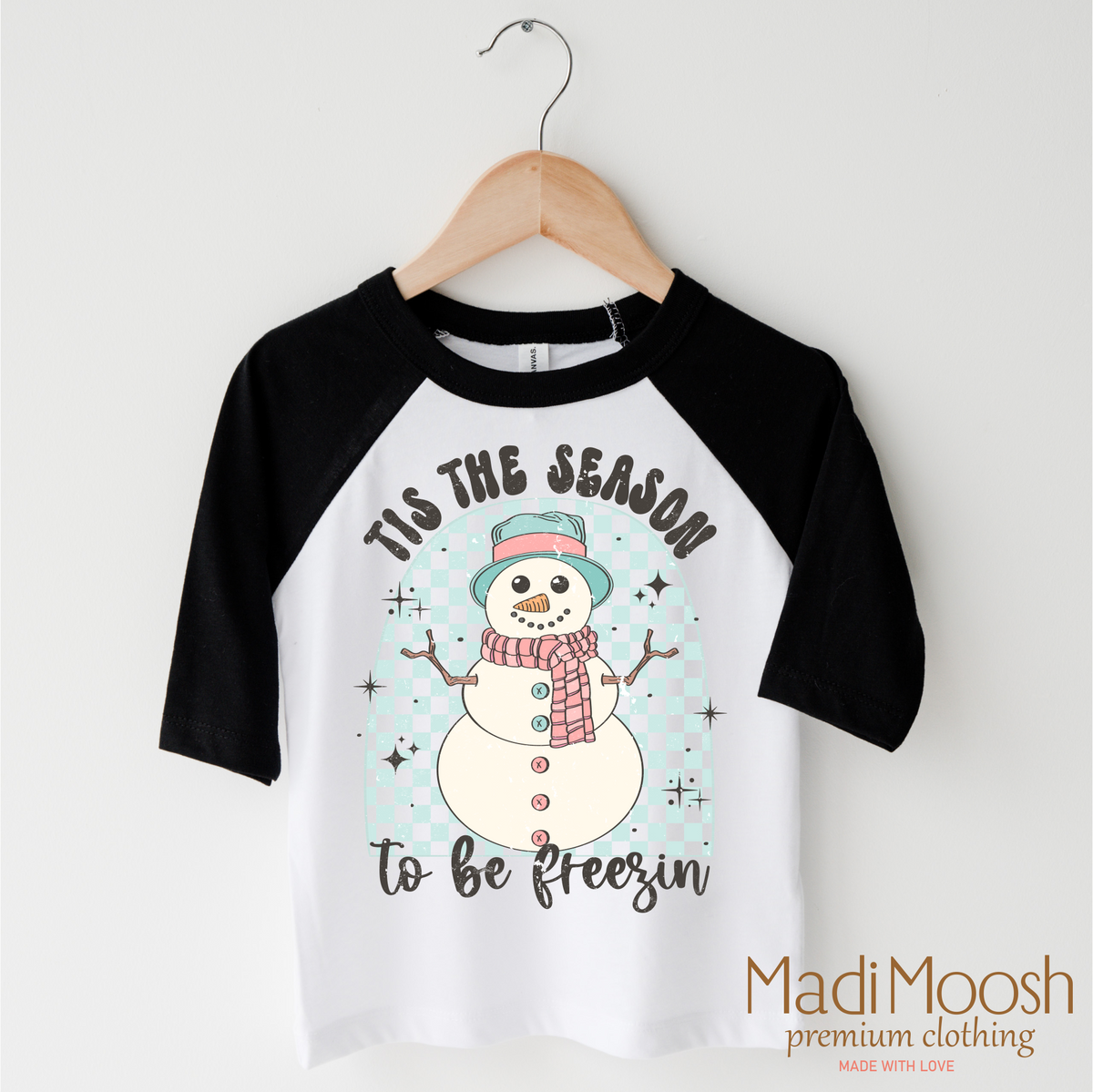 Tis The Season To Be Freezing Christmas design on a black-accented shirt.