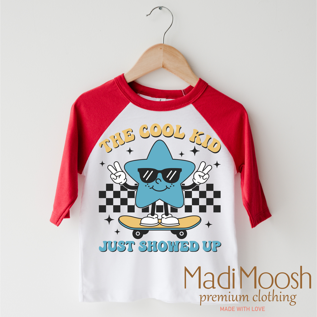 The Cool Kid Just Showed Up Back To School design on a red-accented shirt.