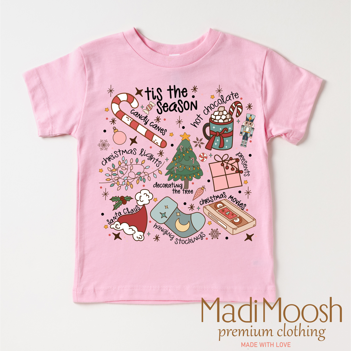 Tis The Season Christmas design on a pink garment.