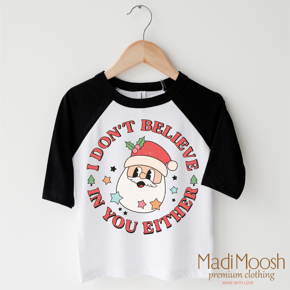 I Don't Believe In You Either Christmas design on a black-accented shirt.