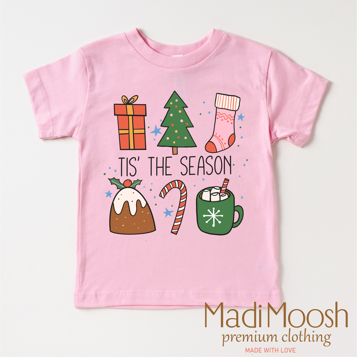 Tis The Season Christmas design on a pink garment.
