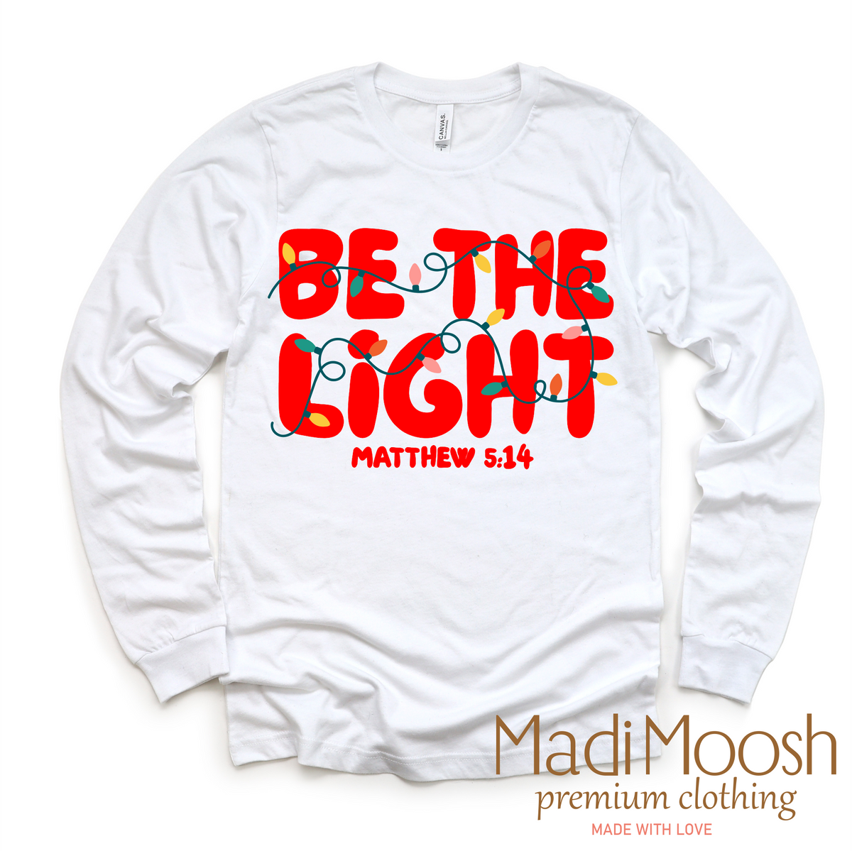 Be The Light Christmas, Christian graphic T-shirt by Madi Moosh