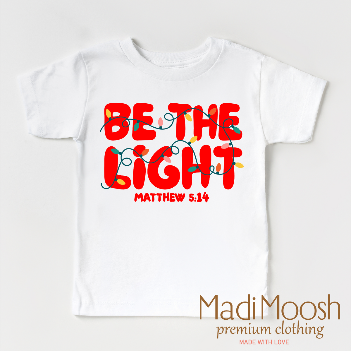 Be The Light Christmas design on a white garment.
