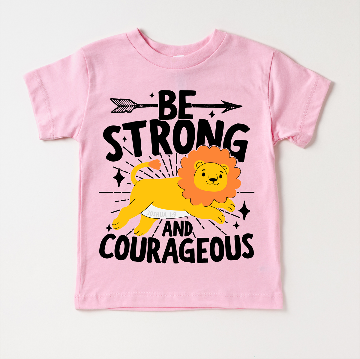 Be Strong And Courageous Christian Lion design on a pink garment.