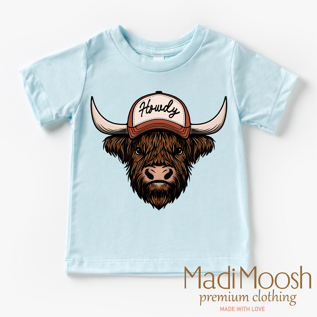 Howdy Highland Cow Western design on a blue garment.