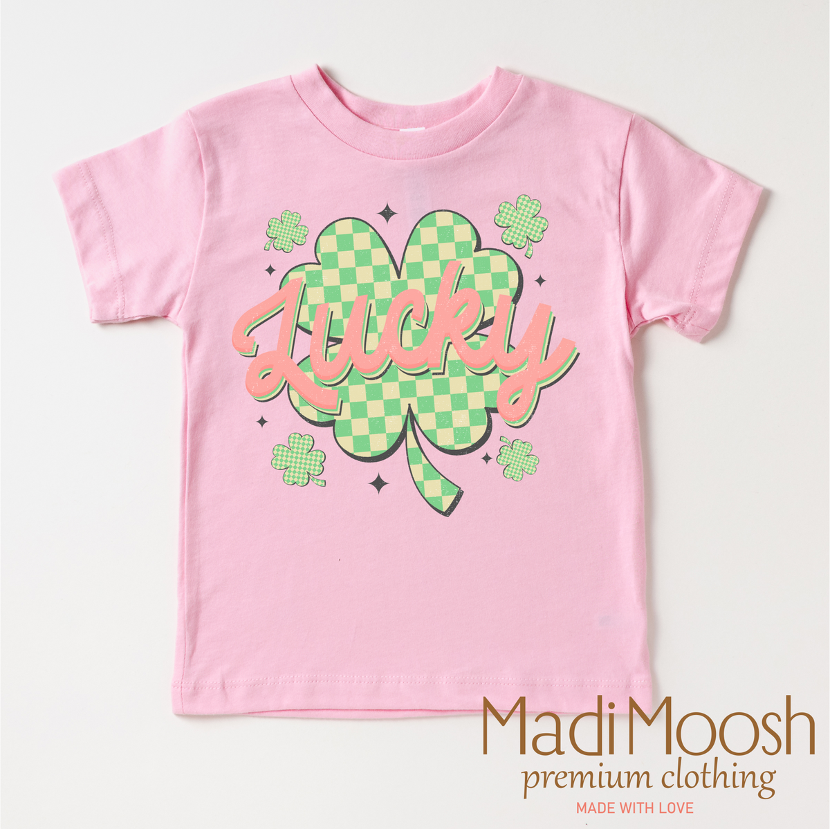 St. Patrick's Day Lucky Clover design on a pink garment.
