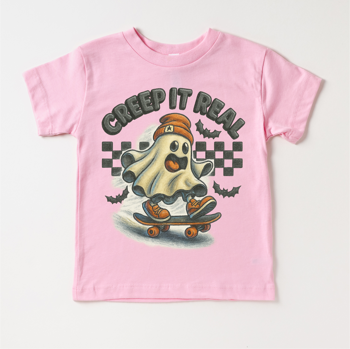 Creep It Real Skateboard Ghost Halloween design on a pink garment.