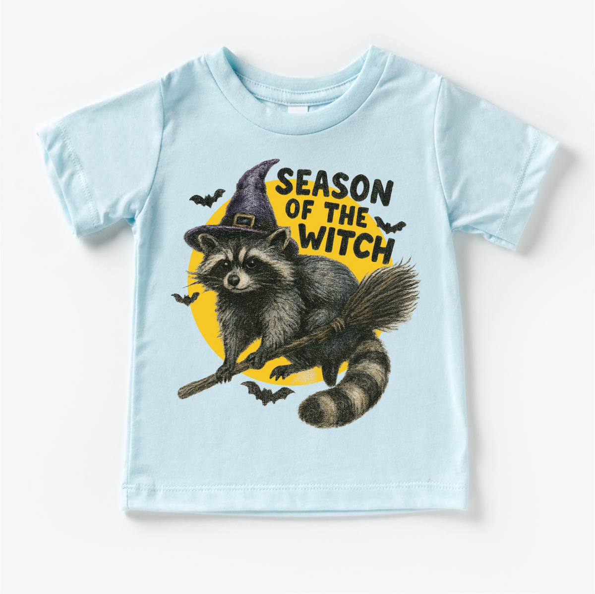 Season Of The Witch Raccoon Halloween design on a blue garment.