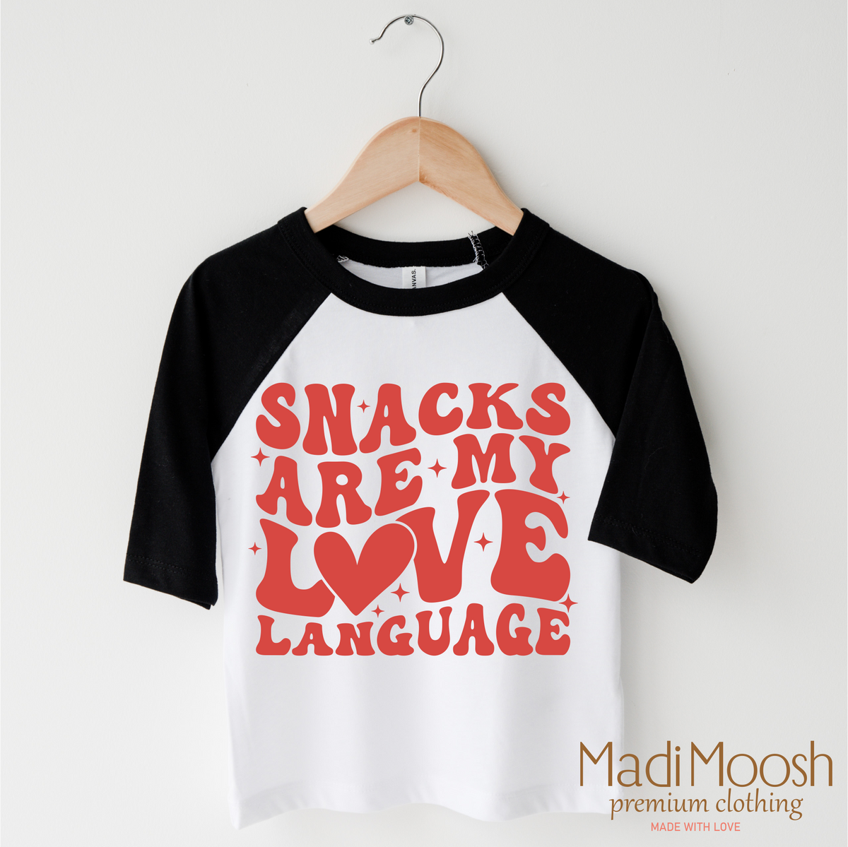 Snacks Are My Love Language Valentine's Day design on a black-accented shirt.