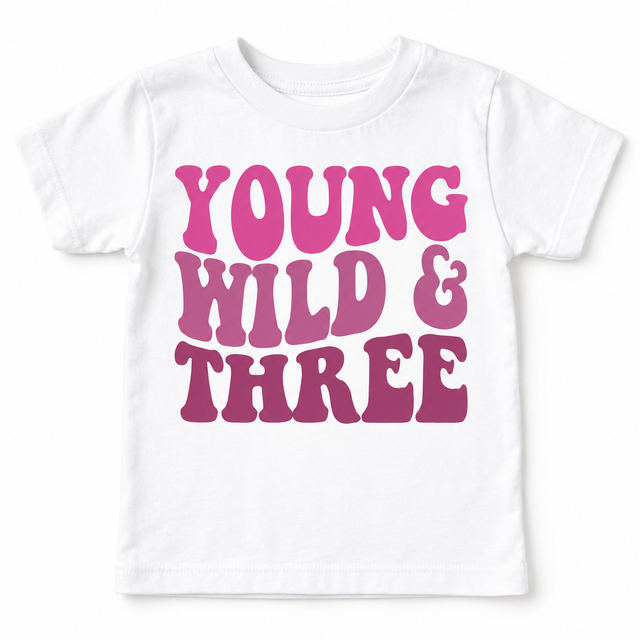 White Young Wild and Three girls birthday tee laid flat with the full pink and mauve design visible.
