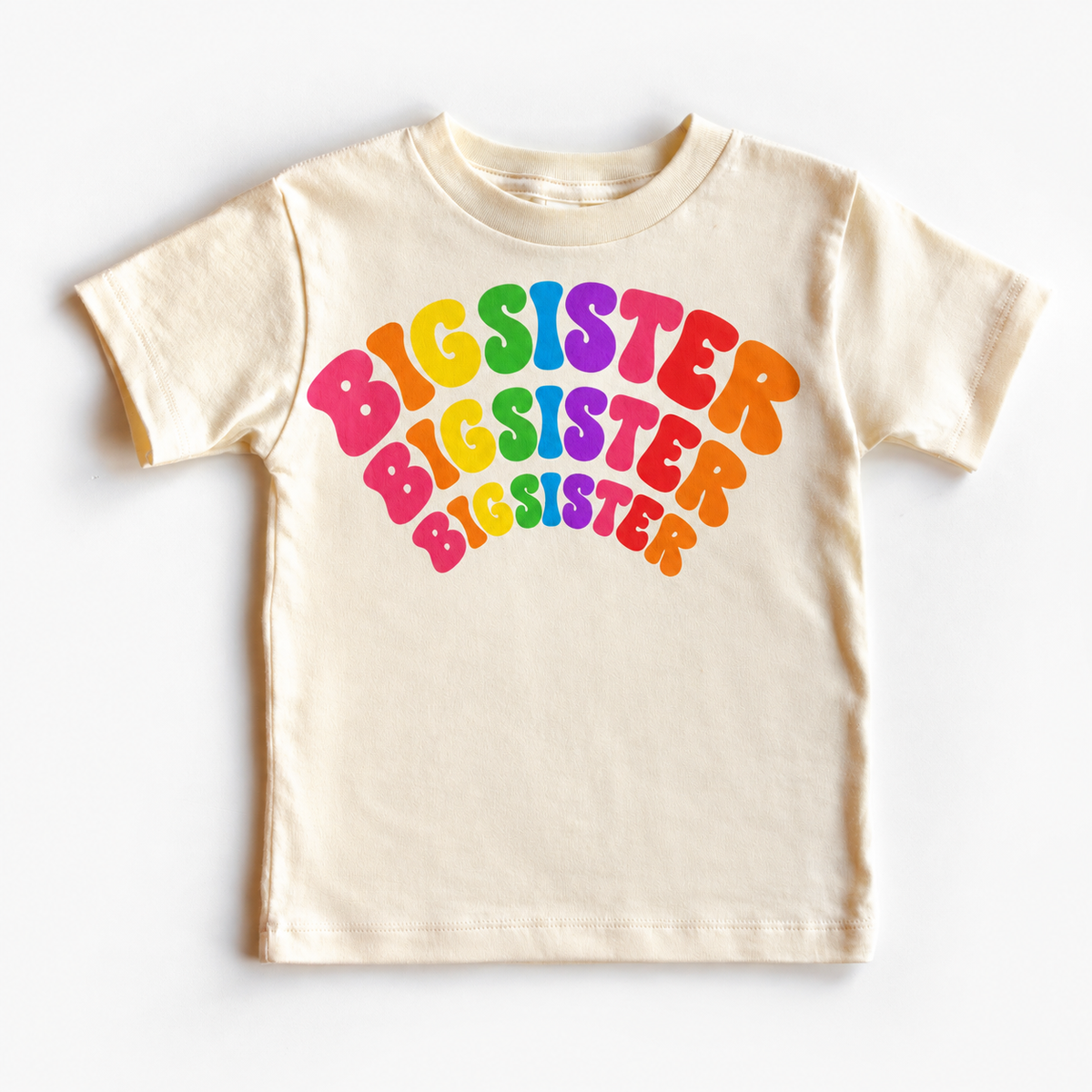 Big Sister rainbow arched lettering on a natural tee