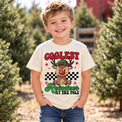 Child wearing natural Coolest Reindeer at the Pole Shirt in a festive Christmas setting