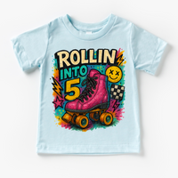 Rollin Into 5 Roller Skating Birthday design on a blue garment.
