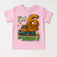 I'm Six And Digging It Birthday design on a pink garment.